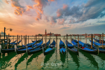 Stunning sunrise over Grand Canal in Venice, Italy. Gondolas moored on the San Marco basin