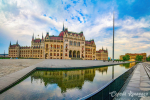Famous Parliament Building mirrored in large reflecting pool on Kossuth Square, Budapest, Hungary