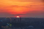 Breathtaking sunset over Lviv city, Ukraine. The aircraft takeoff over the horizon