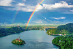 Breathtaking panoramic view of Lake Bled from above with double rainbow on the sky